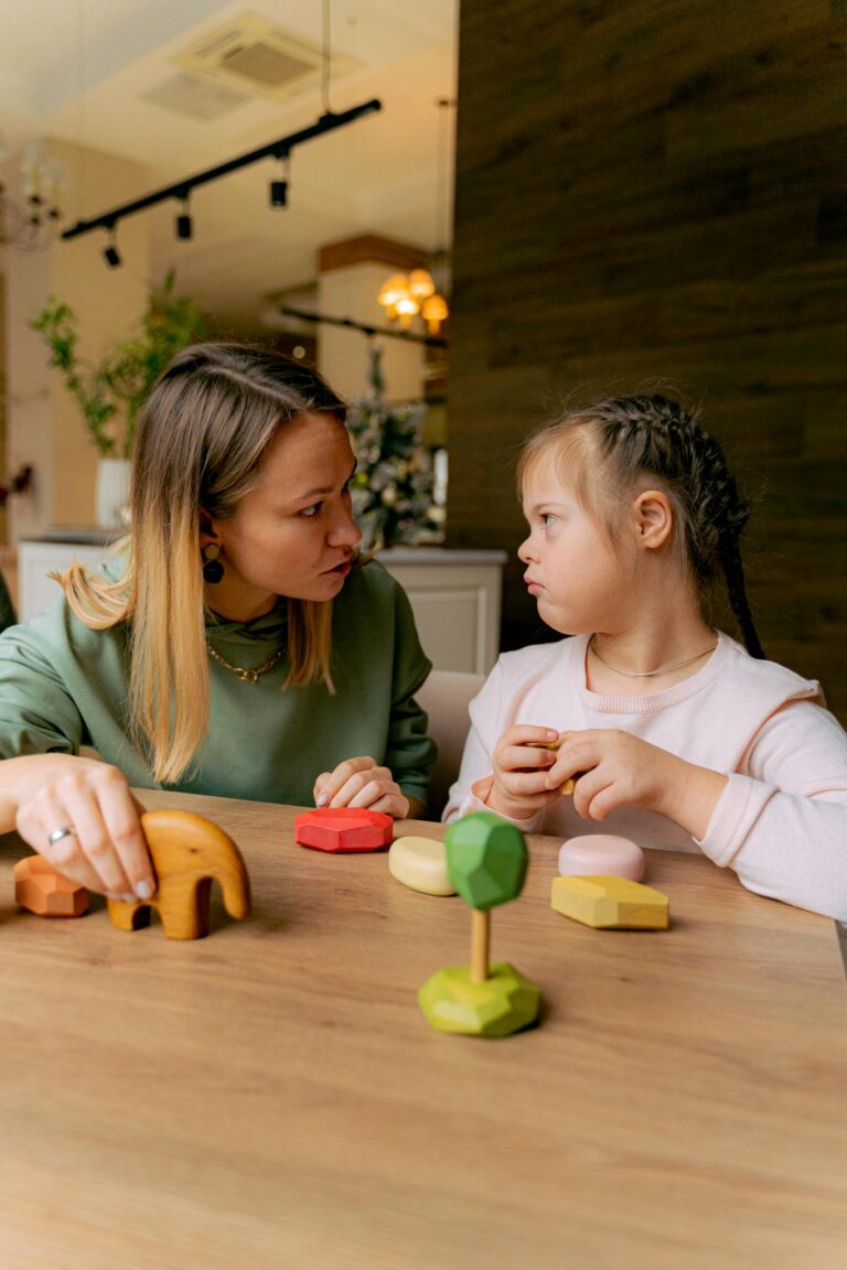 A mother and daughter engaging with wooden educational toys at home, fostering learning and bonding.
